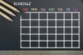 Schedule with grid time table on black chalkboard background Royalty Free Stock Photo