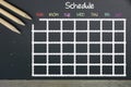 Schedule with grid time table on black chalkboard background Royalty Free Stock Photo