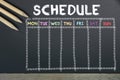 Schedule with grid time table on black chalkboard background