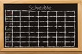 Schedule with grid time table on black chalkboard background