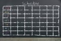 Schedule with grid time table on black chalkboard background