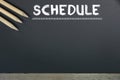 Schedule with grid time table on black chalkboard background Royalty Free Stock Photo