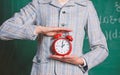 Schedule and regime. Alarm clock in female hands close up. Teachers attributes. Alarm clock in hands of teacher or