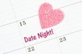 Scheduling your date night with a calendar with a pink heart