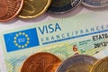 Schengen visa in the passport with a few coins. Issued by the French Embassy. Royalty Free Stock Photo