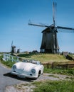 Schermerhorn Alkmaar Netherlands April 2020,. couple doing a road trip with a old vintage sport car White Porsche 356 Royalty Free Stock Photo