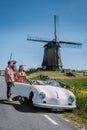 Schermerhorn Alkmaar Netherlands April 2020,. couple doing a road trip with a old vintage sport car White Porsche 356 Royalty Free Stock Photo