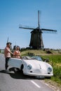 Schermerhorn Alkmaar Netherlands April 2020,. couple doing a road trip with a old vintage sport car White Porsche 356 Royalty Free Stock Photo