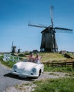 Schermerhorn Alkmaar Netherlands April 2020,. couple doing a road trip with a old vintage sport car White Porsche 356 Royalty Free Stock Photo