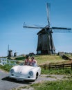 Schermerhorn Alkmaar Netherlands April 2020,. couple doing a road trip with a old vintage sport car White Porsche 356 Royalty Free Stock Photo