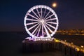 Scheveningen, the Hague illuminated ferris wheel on the pier at night under moonlight Royalty Free Stock Photo