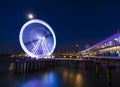 Scheveningen, the Hague illuminated ferris wheel on the pier at night under moonlight Royalty Free Stock Photo