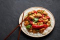 Schezwan Chicken or Dragon Chicken with basmati rice at black slate background