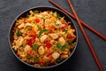 Schezwan Chicken Fried Rice in black bowl at dark slate background. indo-chinese cuisine dish Royalty Free Stock Photo