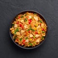 Schezwan Chicken Fried Rice in black bowl at dark slate background. indo-chinese cuisine dish Royalty Free Stock Photo
