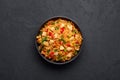 Schezwan Chicken Fried Rice in black bowl at dark slate background. indo-chinese cuisine dish Royalty Free Stock Photo