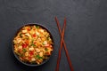 Schezwan Chicken Fried Rice in black bowl at dark slate background. indo-chinese cuisine dish Royalty Free Stock Photo