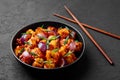 Schezwan Paneer in black bowl at dark slate background. Schezwan Paneer is indo-chinese cuisine dish Royalty Free Stock Photo