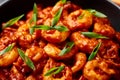 Schezwan Prawns in black bowl at dark slate background. Schezwan Prawns is indo-chinese cuisine curry dish