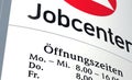 Information sign `Jobcenter` with opening times `Ãâffnungszeiten` in German