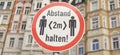 Sign `Keep a distance of 2 m` `2 m Abstand halten` in German Royalty Free Stock Photo