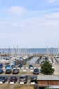Cars parking and sailboats docked at the pier viewed from University of Kiel Sailing Center Royalty Free Stock Photo