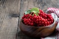 Schisandra chinensis berries in wooden bowl on rustic table Royalty Free Stock Photo