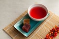 Schizandra tea on a bamboo mat. Selective focus. Traditional ancient Korean drink is brewed from Chinese lemongrass berries. Used