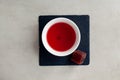 Schizandra tea and fruits marmalade on stone, top view. Traditional Oriental drink is brewed from Chinese lemongrass berries. Used