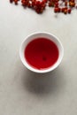 Schizandra tea in white tea cup, selective focus. Traditional Oriental drink is brewed from Chinese lemongrass berries. Used in