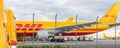 Schkeuditz, Germany - 29th May, 2022 - Many courier van against cargo planes parked on Leipzig Halle airport terminal Royalty Free Stock Photo