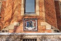 Details of the Schladming Town Hall: red brick wall and coat of arms of the city. City bears arms showing a kneeling miner Royalty Free Stock Photo