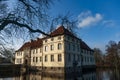 Schloss Strunkede grom the bare branches on a sunny morning in Herne