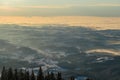 Schoeckl - A sunrise seen from snow-capped peak of Schoeckl in Austrian Alps. The sky is bursting with orange and pink