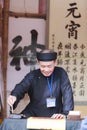 A scholar writes Chinese calligraphy characters at Temple of Literature