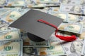 Scholarship concept. Graduation cap on banknotes, closeup