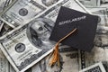 Scholarship graduation cap on cash Royalty Free Stock Photo