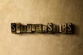 SCHOLARSHIPS - close-up of grungy vintage typeset word on metal backdrop