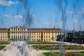 the Schonbrunn Palace elevation seen through waterfall and screen. Baroque exterior. windows and stairs. beautiful garden Royalty Free Stock Photo