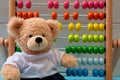 School abacus with colorful beads and cute teddy. Kids learning count  children math class concept Royalty Free Stock Photo