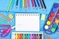 School accessories on blue boards, back to school concept, copy space for text in notepad Royalty Free Stock Photo