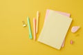 School accessories concept. Top view photo of colorful stationery stack of diaries round correction tape binder clips and pens on