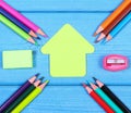 School accessories and shape of school building on blue boards, copy space for text Royalty Free Stock Photo