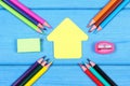 School accessories and shape of school building on blue boards, copy space for text Royalty Free Stock Photo