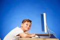 School-age boy sitting in front of the monitor laptop at studio Royalty Free Stock Photo