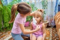 A school-age girl puts a medical mask on her little sister. Children play doctor and hospital Royalty Free Stock Photo