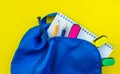 School backpack, pencil, pen, markers, and notepad on a yellow background Royalty Free Stock Photo