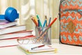 School backpack with school supplies. Books, metal stand for pen