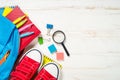 School backpack with stationery on white background. Royalty Free Stock Photo