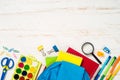 School backpack with stationery on white background. Royalty Free Stock Photo